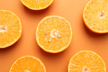 Fresh juicy tangerines on orange background, flat lay