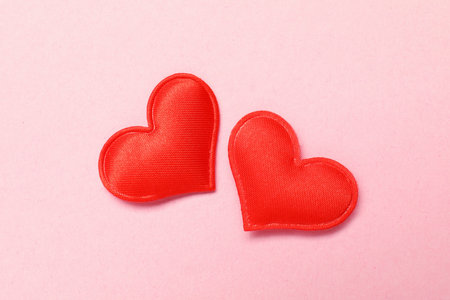 Red hearts on pink background, flat lay