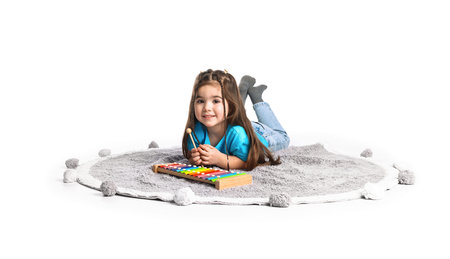 Cute little girl playing toy xylophone on white backgroundの写真素材