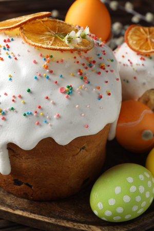 Beautiful Easter cakes and eggs on wooden table, closeup