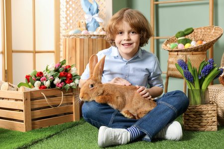 Little boy with cute Easter bunny indoors