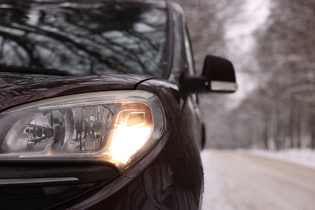 Modern car parked near road and trees on winter day, closeupの写真素材