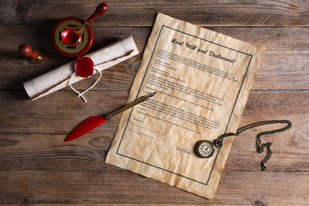 Last Will and Testament, chain watch, pen, wax seal and paper scroll on wooden table, flat layの写真素材