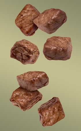 Roasted beef pieces falling on color gradient backgroundの写真素材
