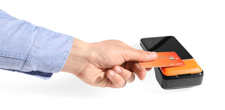 Man with credit card using payment terminal on white background, closeup