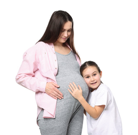 Pregnant woman and her daughter on white background