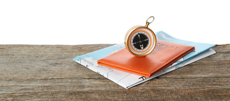 Journey. Compass, world map and passport on wooden table against white background