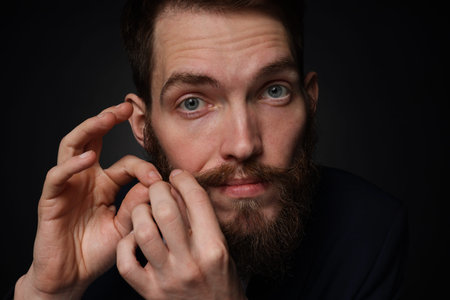 Man with stylish mustache and beard on black backgroundの写真素材