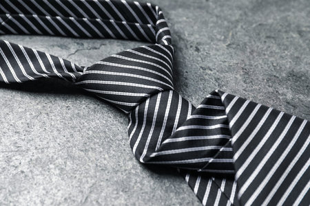 Stylish striped tie on gray table, closeupの写真素材