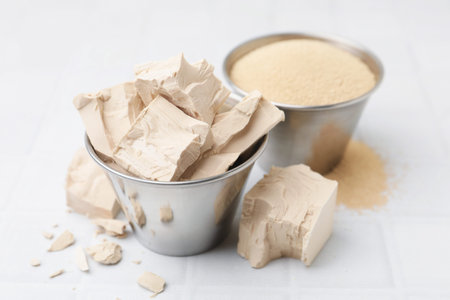 Fresh and dry yeast on white tiled table, closeupの写真素材