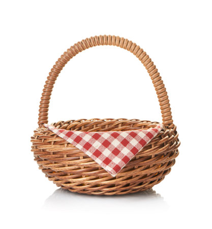 Wicker basket with napkin isolated on whiteの写真素材
