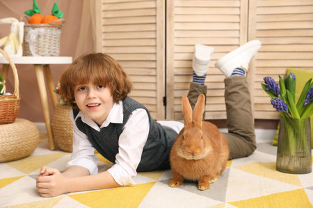 Little boy with cute Easter bunny indoorsの写真素材