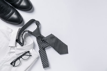Flat lay composition with stylish tie and shoes on white background. Space for textの写真素材