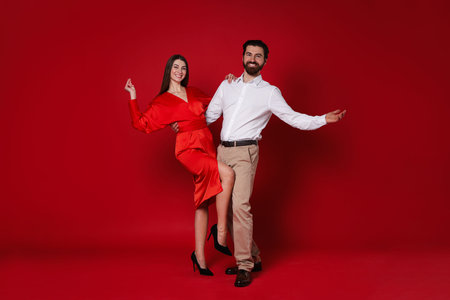 Romantic date. Portrait of lovely couple on red backgroundの写真素材