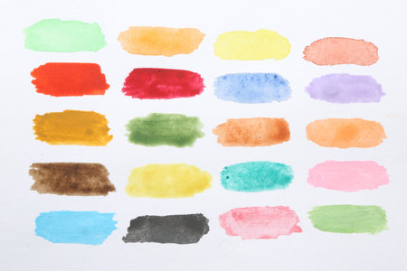 Painted watercolor strokes on white sheet of paper, top viewの写真素材