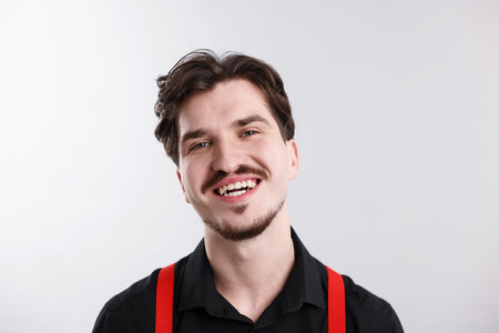 Handsome man with mustache on light backgroundの写真素材