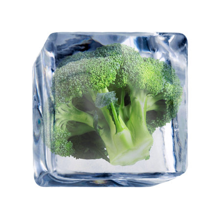 Green broccoli frozen in ice cube on white backgroundの写真素材