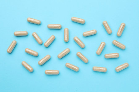 Pills on light blue background, flat layの写真素材