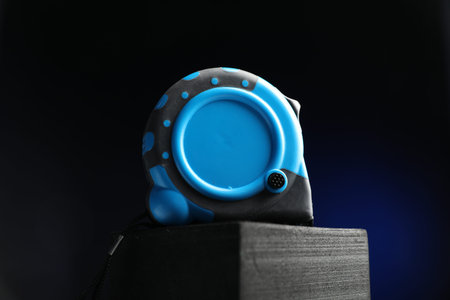 Measuring tape on block against black background, closeupの写真素材