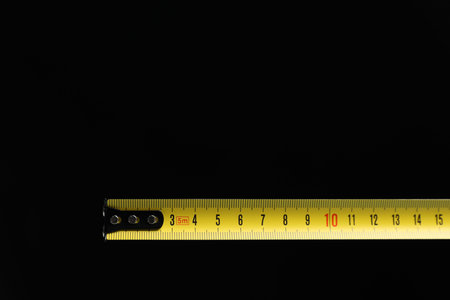 Measuring tape on black background, closeup. Space for textの写真素材