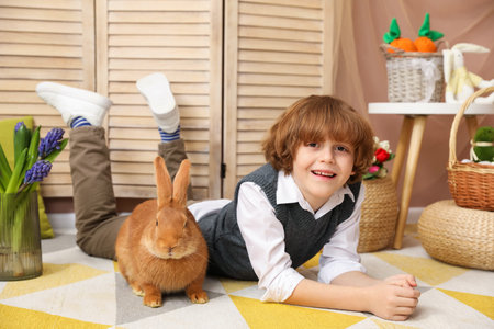Little boy with cute Easter bunny indoorsの写真素材