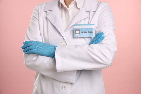 Doctor with badge on pink background, closeup