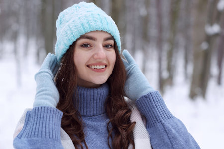 Portrait of beautiful woman in snowy forestの写真素材