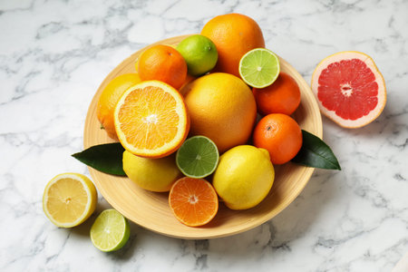 Different ripe citrus fruits on white marble table, closeupの写真素材