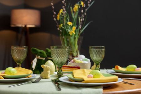Festive table setting with elegant dishware and painted eggs, closeup