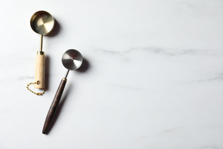 Different scoops on white marble table, flat lay. Space for text