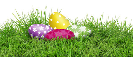 Easter eggs in green grass against white background