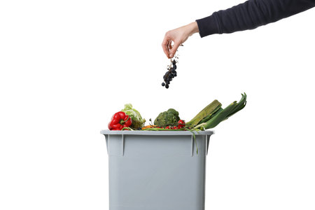 Woman garbage throwing into trash bin on white background, closeup. Waste sorting
