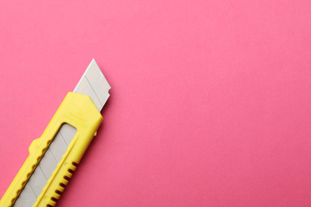 One sharp knife on pink background, top view. Space for textの写真素材