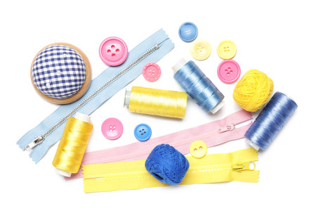 Sewing supplies on white background, top view