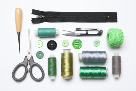 Flat lay composition with sewing supplies on white background