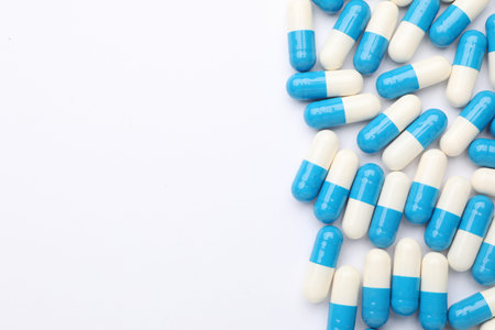 Many pills on white background, flat lay. Space for text
