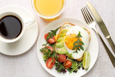 Healthy breakfast with avocado toast served on light table, flat lay