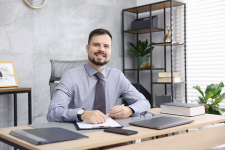 Portrait of notary at wooden desk in office