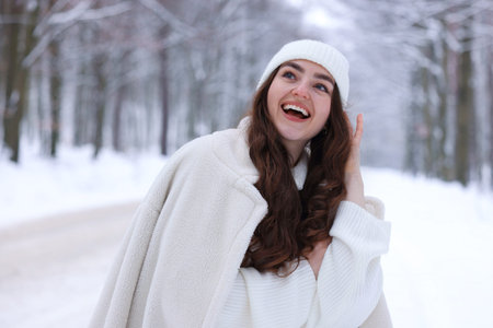 Portrait of beautiful woman in snowy forest