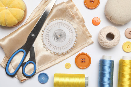 Flat lay composition with sewing supplies on white background