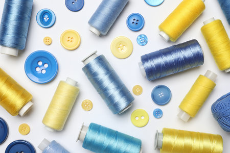 Flat lay composition with sewing supplies on white background