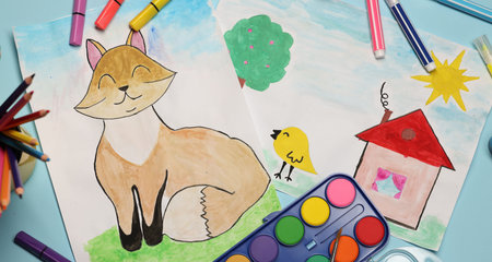 Child's drawings, felt-tip pens, paints and pencils on light blue background, flat layの写真素材