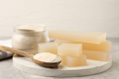 Gelatin powder and jelly pieces on gray table, closeupの写真素材