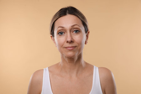 Woman with healthy skin on beige backgroundの写真素材