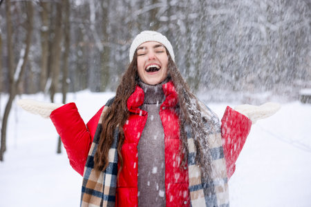 Beautiful woman having fun in snowy forest