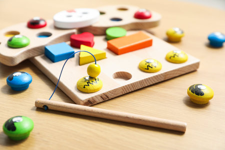 Child's toy. Magnetic sorting set for children with toy hen, figures and fishing rod on wooden table, closeupの写真素材