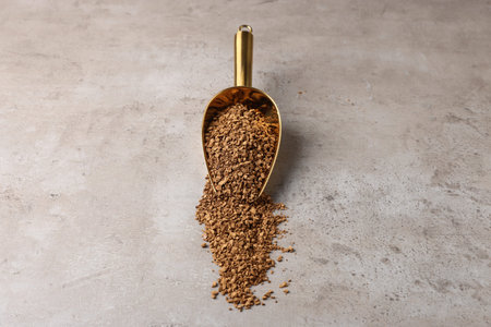 Instant coffee and metal scoop on gray textured tableの写真素材