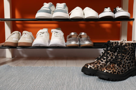 Different stylish children's shoes on shelves indoors, closeupの写真素材