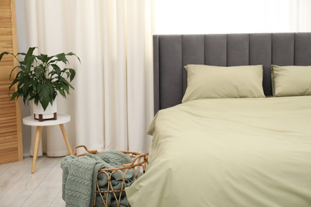 Comfortable bed with stylish lines at home, closeupの写真素材