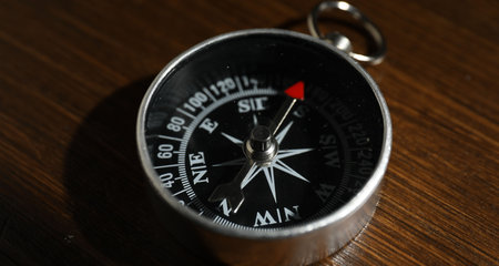 One compass on wooden table, closeup viewの写真素材